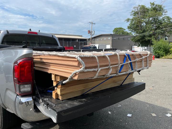 A pickup full of plywood: doesn't look much like a boat yet