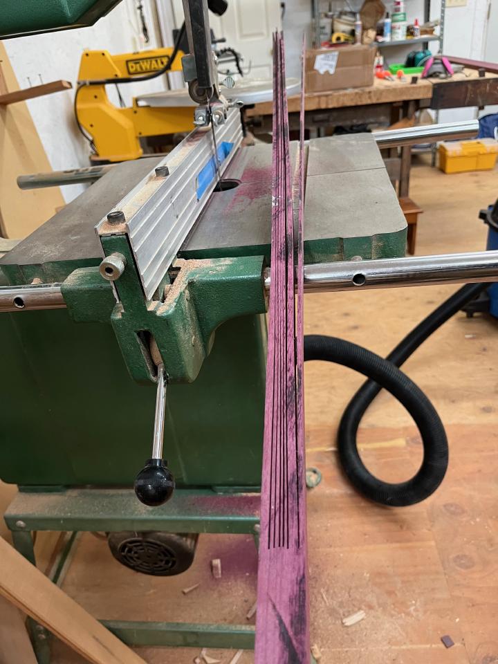 The forward most section of the keel has slightly more bend than the purpleheart will take, so we cut kerfs with the bandsaw and laminate a bend into the keel